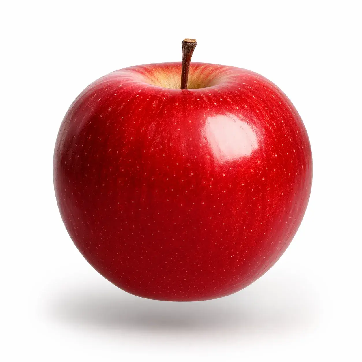Una manzana roja brillante flotando sobre un fondo blanco puro